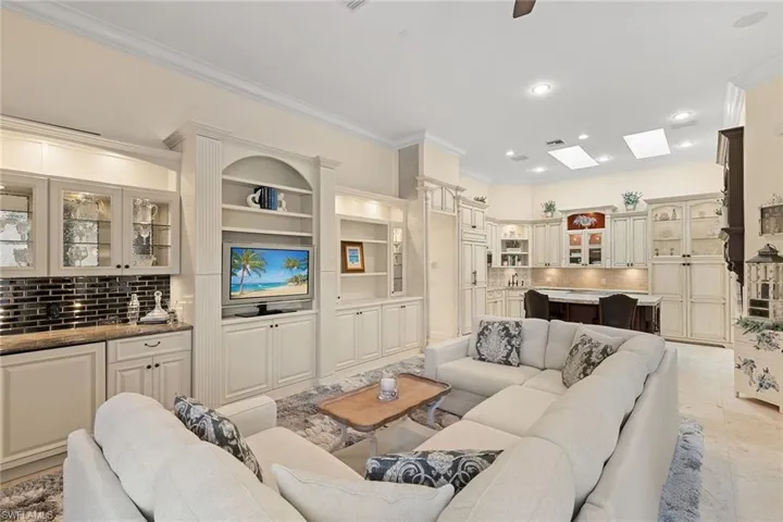 Living room featuring crown molding and recessed lighting