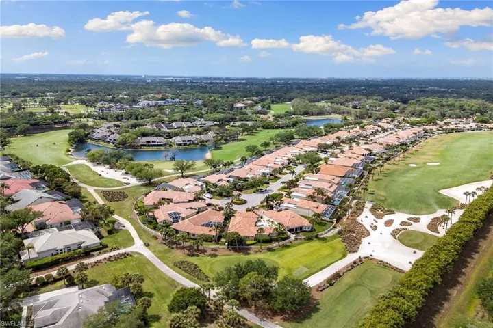 Aerial view of property and surrounding area with a golf club and nearby suburban area