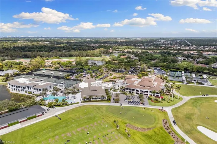 Drone / aerial view of a nearby body of water and a golf club