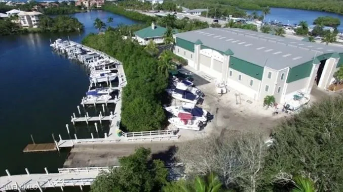 Extensive boat storage facility featuring multiple docking slips, a large dry storage building with multiple bays, and a boat ramp for water access