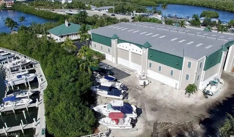 Expansive marina with multiple boat slips, large boat storage facility, and waterfront access