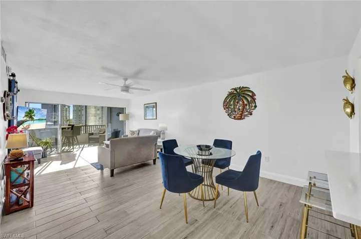Dining area with light wood-type flooring and a ceiling fan