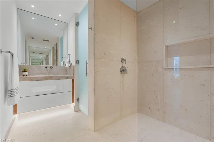Spacious walk-in shower and dual vanities.