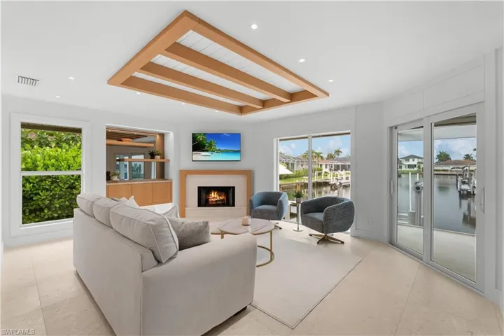 Living Room features fireplace, dry bar, wood beam feature, and shiplap detail.