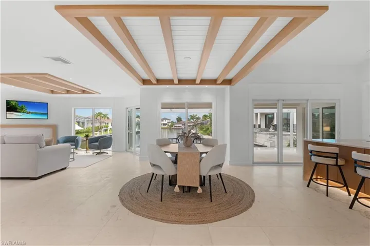 Open concept kitchen/dining/great room, all with a view of the water.