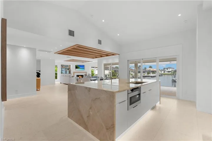 Island kitchen and soaring ceilings.