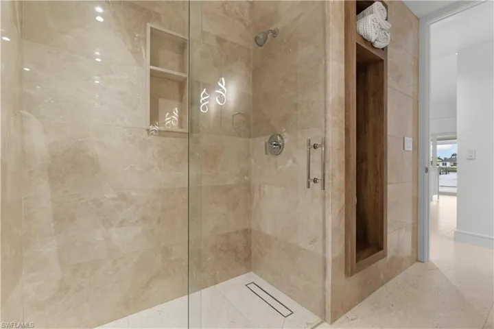 Guest bath features large shower and built-in linen closet