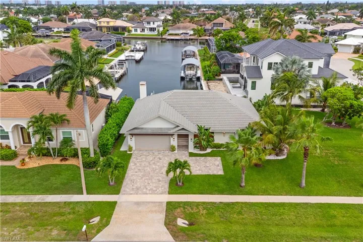 Totally remodeled single family home on the canal with boat lift, flat tile roof, side corner lot.