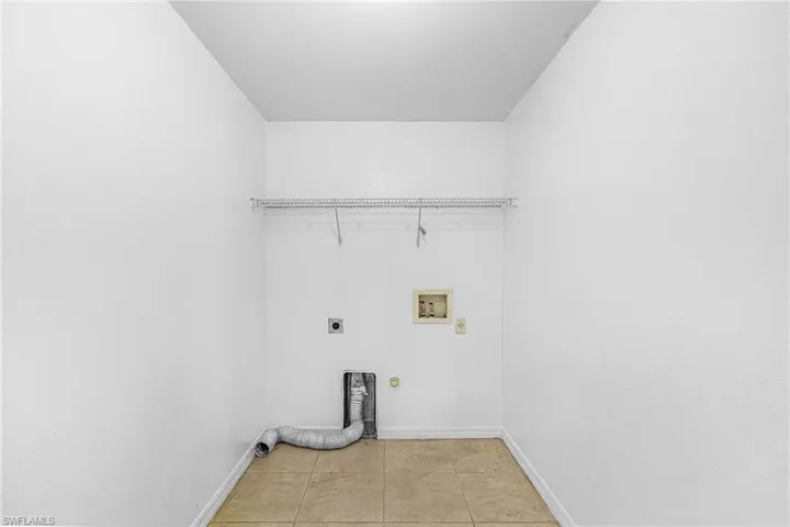Laundry area featuring a wire shelf, utility hookups, and tiled flooring