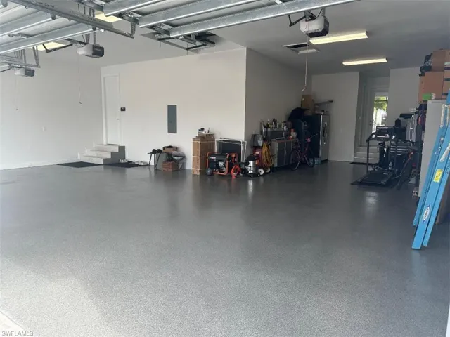 4 Car Garage with 1/2 bath and separate conditioned storage room