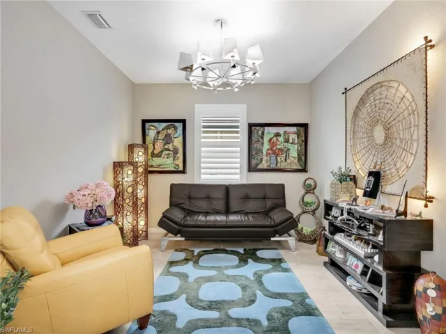 Living area featuring a chandelier and light wood-style flooring
