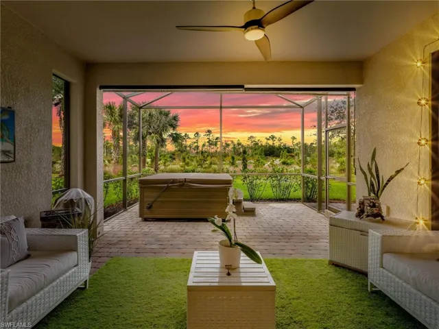 Sunroom / solarium featuring a jacuzzi