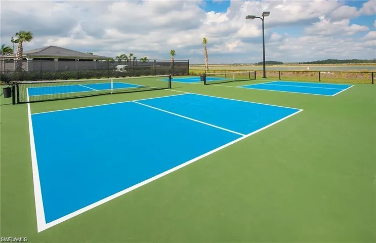 View of tennis court with community basketball court