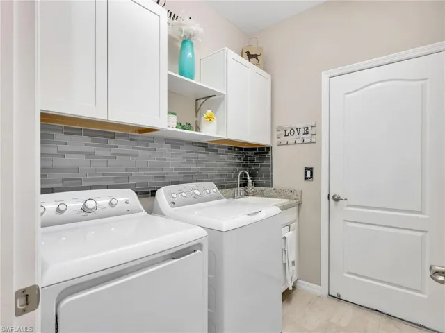 Laundry room with cabinet space and washing machine and clothes dryer