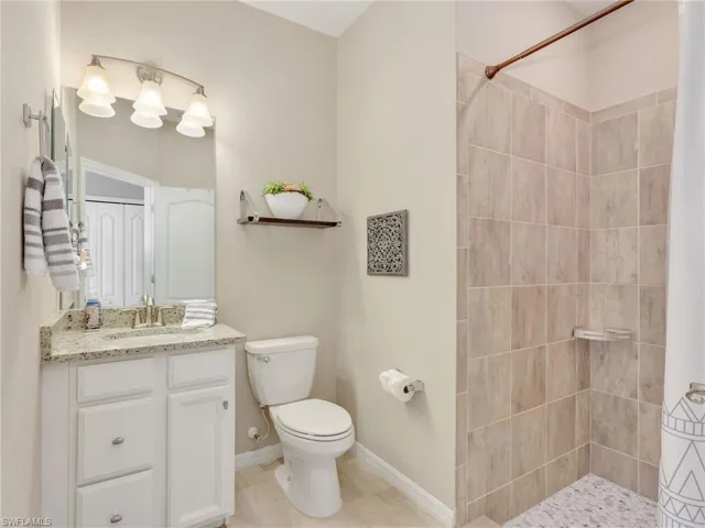 Full bath with vanity and tiled shower