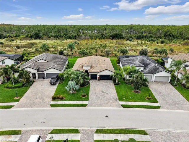 Aerial view of residential area featuring a forest