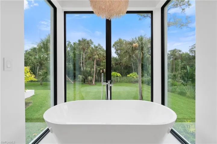 Bathroom with tile patterned flooring, shower with separate bathtub, and a healthy amount of sunlight