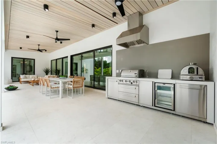 Kitchen with ceiling fan, wine cooler, and wood ceiling