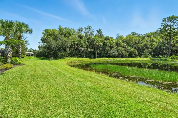 View of green lawn featuring a water view
