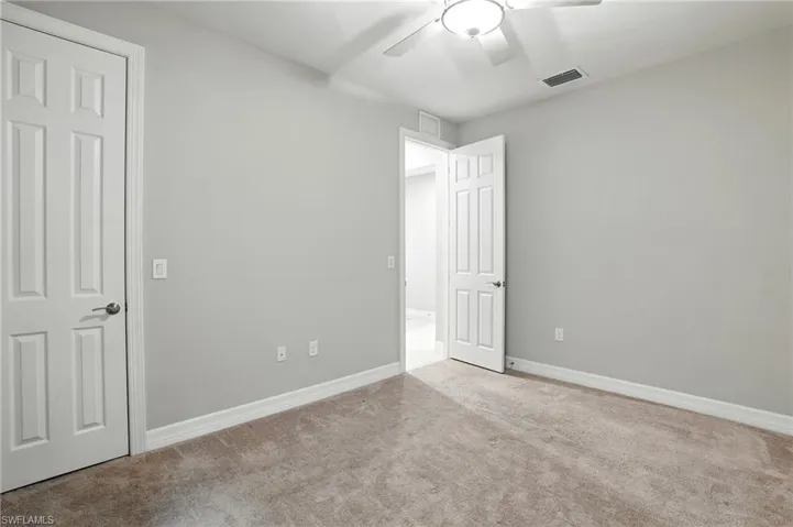 Unfurnished bedroom with carpet flooring and a ceiling fan