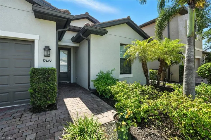 View of exterior entry featuring stucco siding and a garage