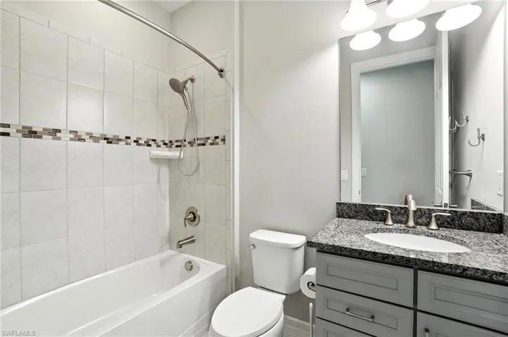 Full bath featuring tub / shower combination and vanity