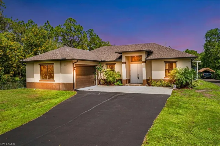 Prairie-style house with a garage and a lawn