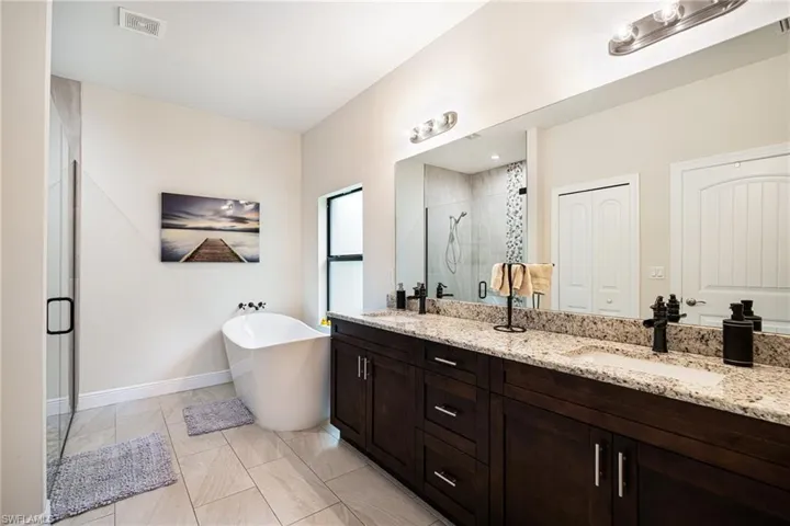 Bathroom featuring independent shower and bath and vanity