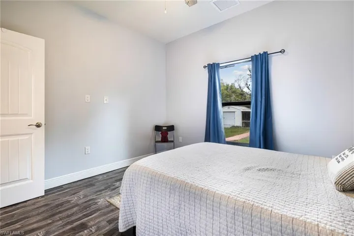 Bedroom with dark hardwood / wood-style floors