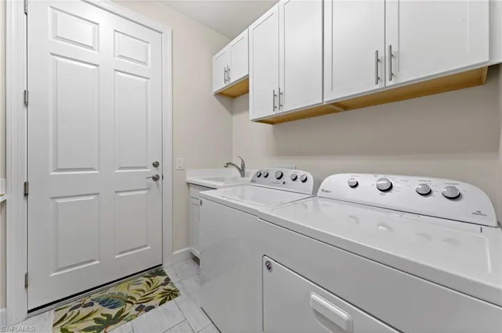 Laundry rom w/upper cabinets and laundry sink