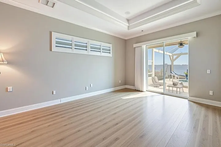 Virtually modified photo-OWNER'S BEDROOM W/LUXURY VINYL FLOORING & SLIDERS TO LANAI & RIVER VIEW