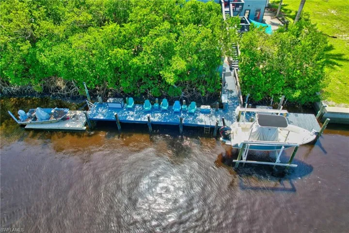 Waterfront property with a long dock, boat lift, and additional floating dock