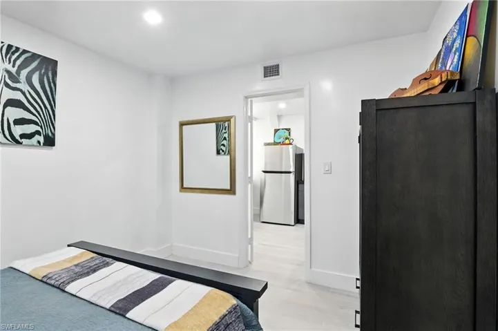 Interior room with light-toned flooring and white walls