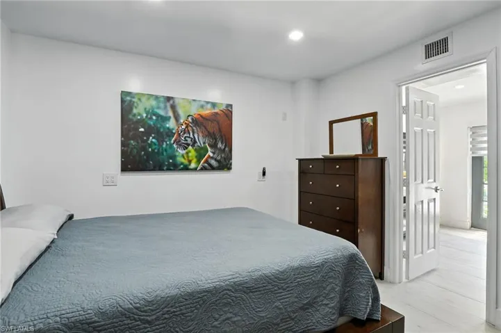 White walls featuring recessed lighting and a white six-panel door