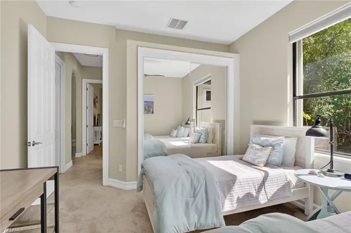 Carpeted bedroom with a closet and baseboards