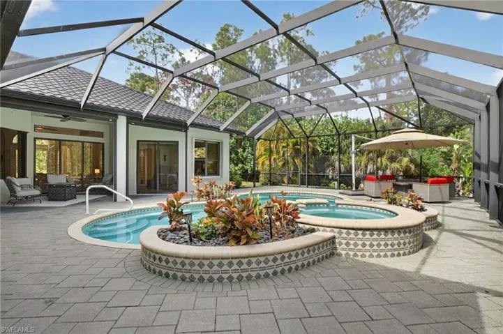 Integrated pool / spa with an outdoor lounge area, glass enclosure, a sunroom, and a patio