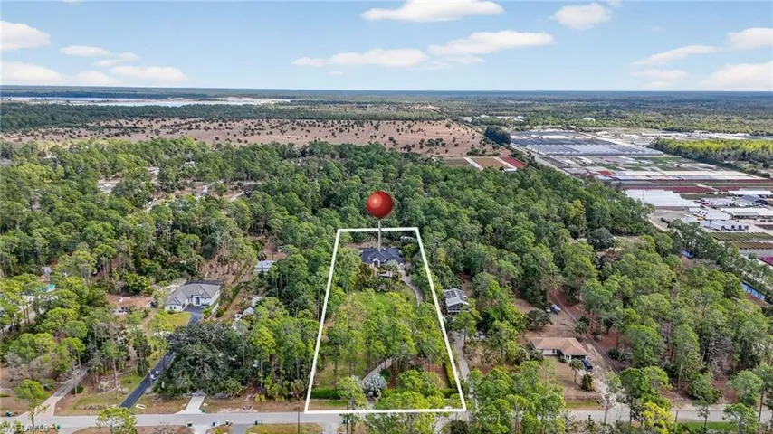 View of property location featuring property boundaries highlighted and a forest