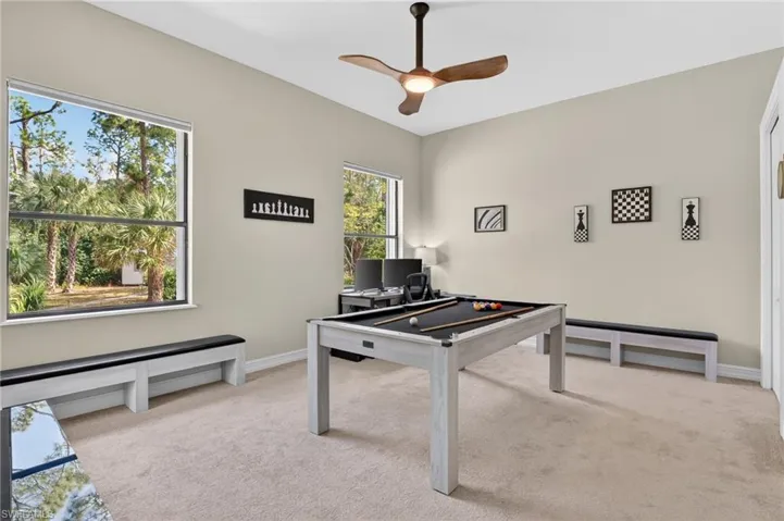 Rec room featuring light carpet, ceiling fan, and pool table
