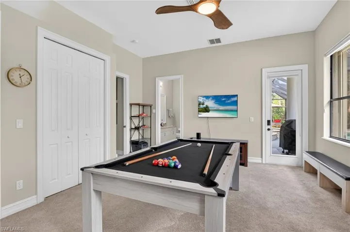 Playroom featuring a ceiling fan, light colored carpet, and billiards table