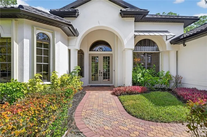 Property entrance with french doors and stucco siding
