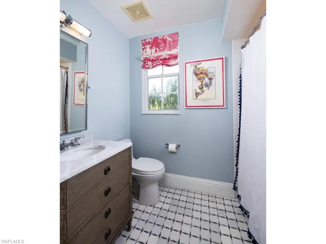 Full bath with vanity and tile patterned floors