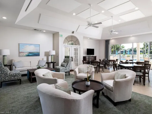 Tiled living room with recessed lighting, a ceiling fan, and coffered ceiling