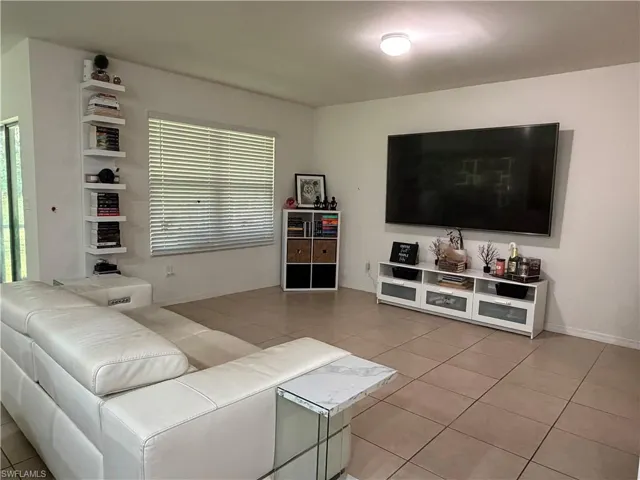Spacious interior room featuring light-toned tile flooring throughout
