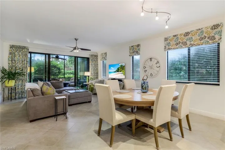 Tiled dining area featuring ornamental molding and ceiling fan
