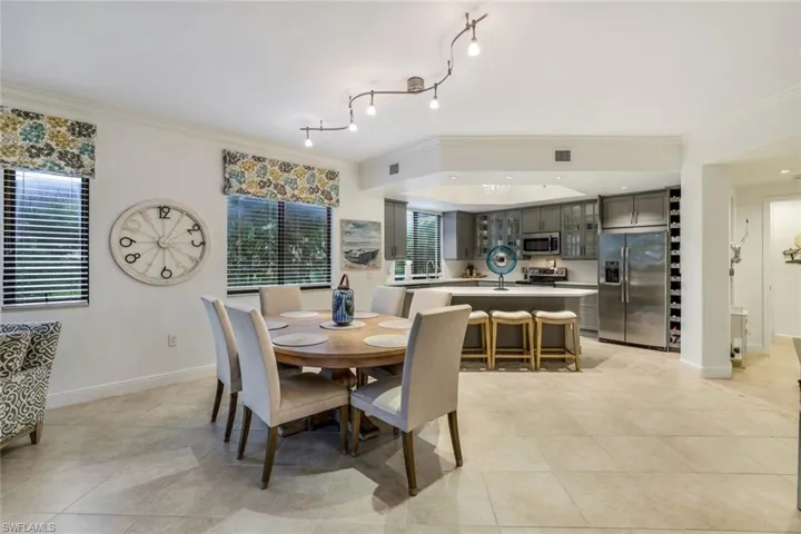 Dining room featuring ornamental molding and light tile patterned flooring