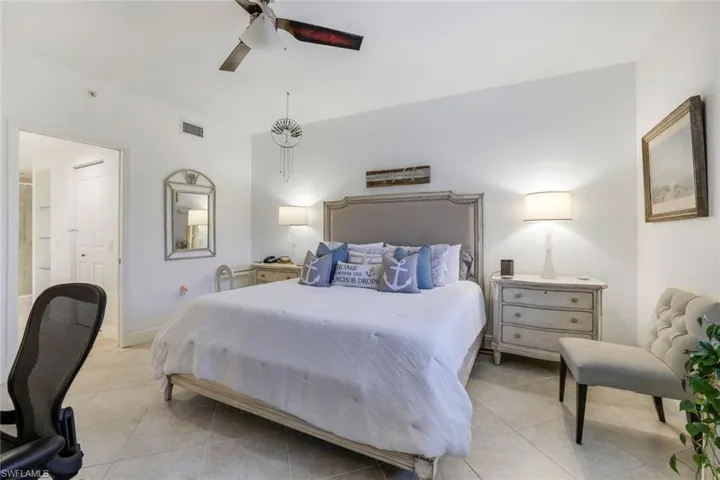 Bedroom with light tile patterned flooring and ceiling fan