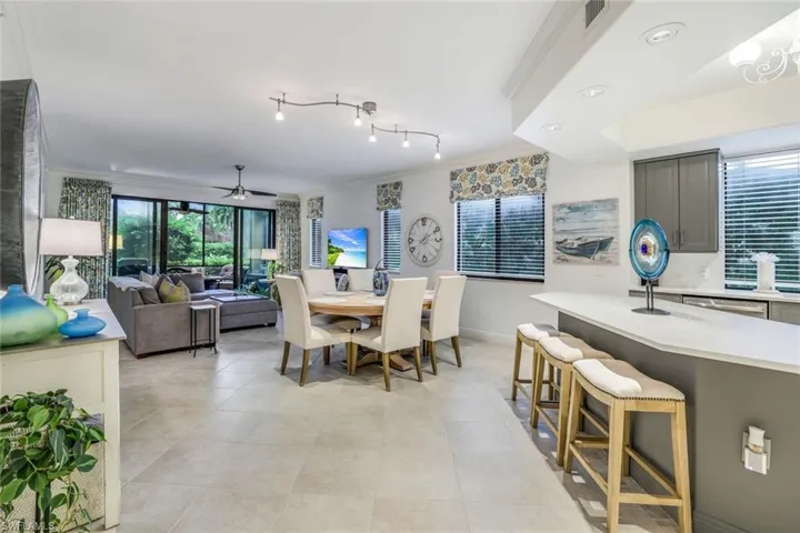 Tiled dining area featuring crown molding and ceiling fan