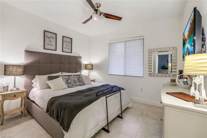 Bedroom featuring light tile patterned floors and ceiling fan