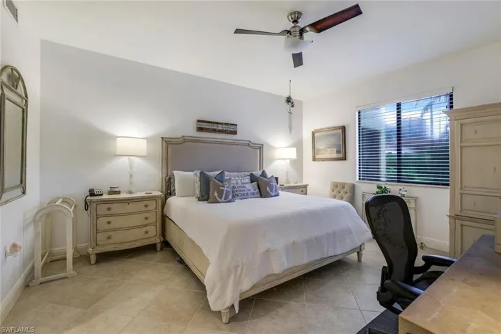 Bedroom with ceiling fan and light tile patterned floors