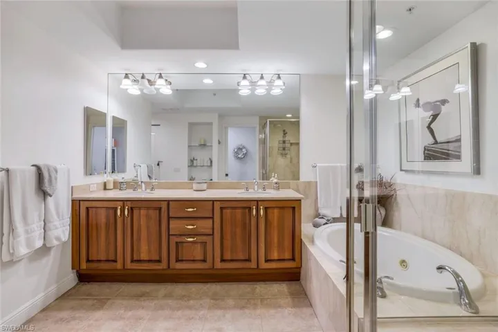 Bathroom with vanity, independent shower and bath, and tile patterned floors